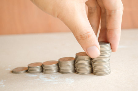Coins of Thailand on wooden floor