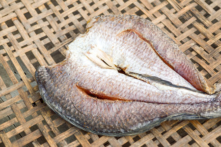 Dried Striped snakehead fish with salt on the bambooの写真素材