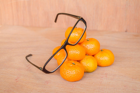 orange and glasses on wooden floorの写真素材