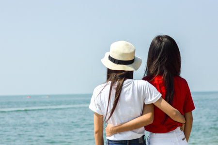 two girl hug on the beachの写真素材