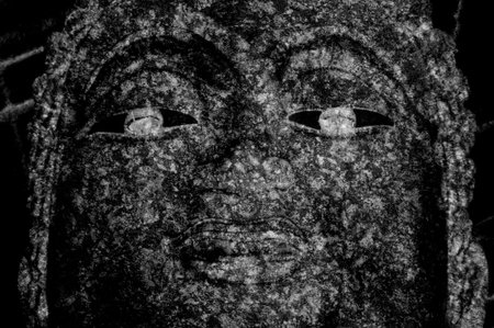 dark buddha statue face textureの写真素材