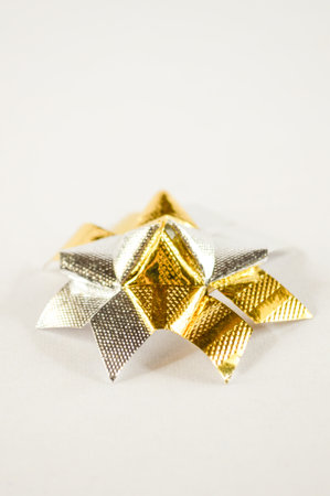 gold silver ribbon flower on white background