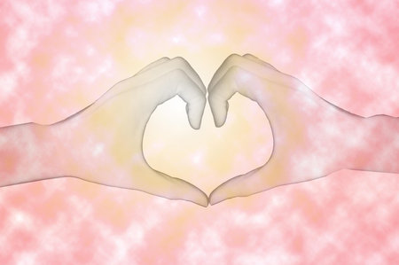 heart shape by hand (abstract pink background)の写真素材