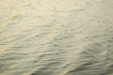 water surface with ripples and reflection of landscape