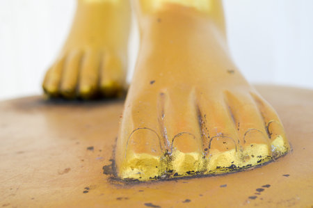 foot gold buddha statue in temple thailand (focus foot)の写真素材