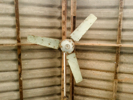Old fan hanging on roofの素材