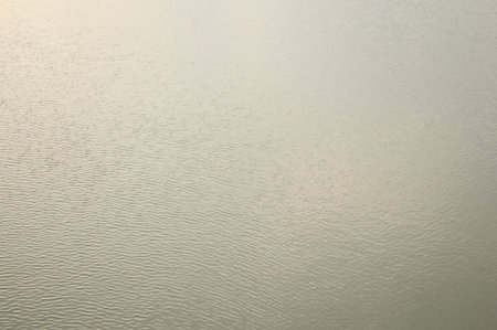 water surface with ripples and reflection of landscapeの写真素材