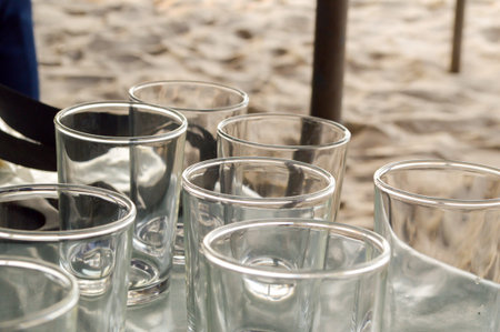 water glass empty on table near beachの写真素材