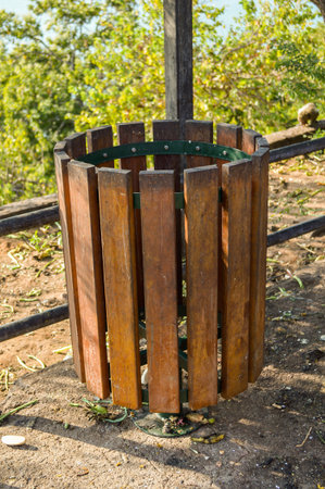Wood trash bin in green parkの写真素材