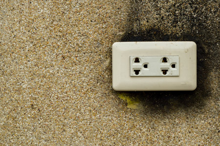 Dirty electric plug on grunge cement wallの写真素材