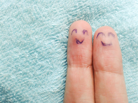 two fingers on blue fabricの写真素材