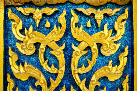 art thai gold pattern wall in public temple Thailandの写真素材