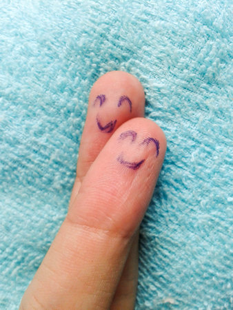 two fingers on blue fabricの写真素材