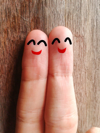 two happy fingers on wood floorの写真素材
