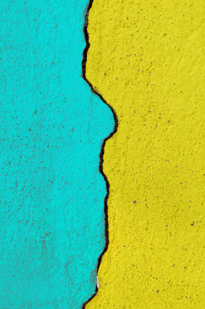 blue and yellow color on crack cement wallの写真素材