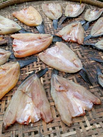 Dry salted fish on bamboo floor