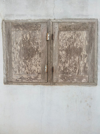 old vintage wood window on cement wall in country Thailandの写真素材