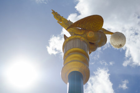 golden swan lamp post in gardenの写真素材