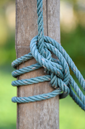 rope tied wood pole close upの写真素材