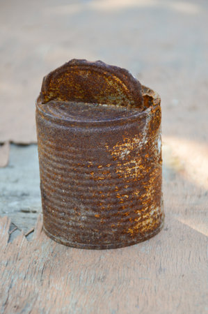 rusty can on wood plank