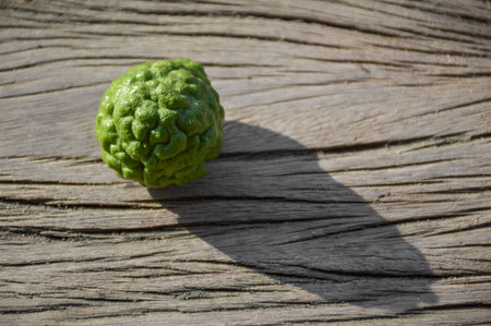 kaffir Lime or Bergamot fruit on wood plankの写真素材