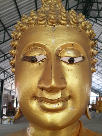 close up gold buddha statue in public temple thailandの写真素材