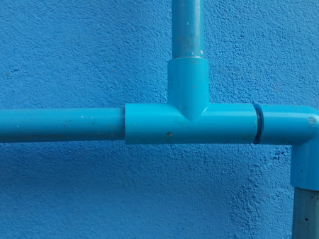pvc pipe on blue cement wall textureの写真素材
