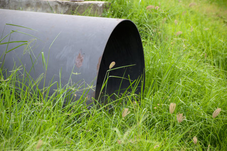 pipe on the ground in gardenの写真素材