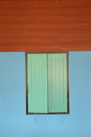 old vintage wood window on cement wall in country Thailandの写真素材
