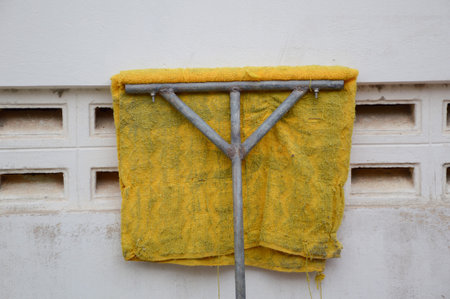 old mops on cement wallの写真素材
