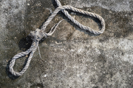 old rope on cement floorの写真素材