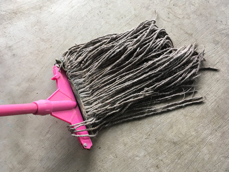 close up old mop on cement floorの写真素材