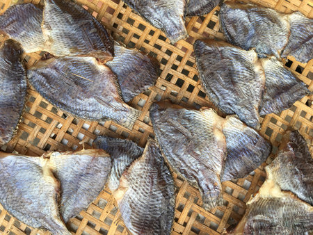 dry salty nile tilapia fish on bamboo floorの写真素材