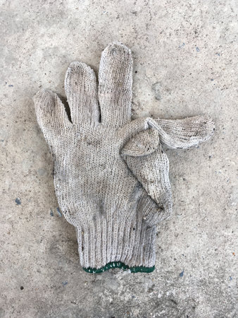 old glove on cement floorの写真素材