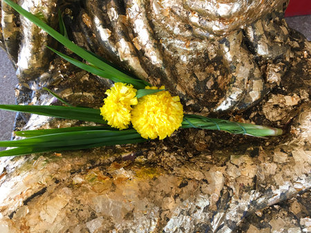 marigold flower on gold buddha statue in temple Thailandの写真素材