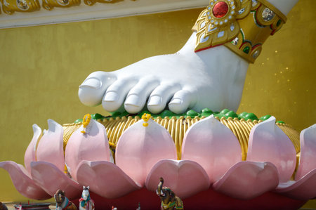 close up foot big white statue of brahma on lotus in public temple at Thailandの写真素材