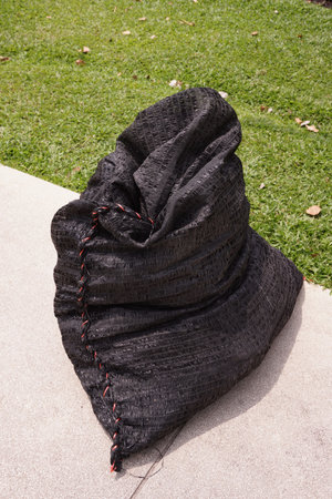 black set sack on the ground in garden