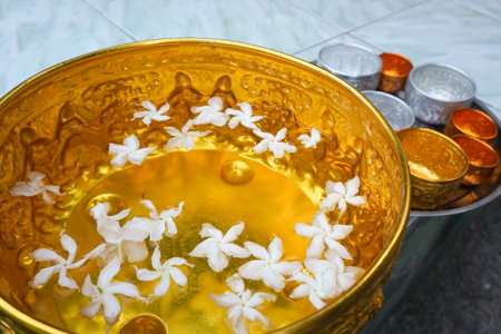 Water in water dipper with colorful flowers pedestalの写真素材