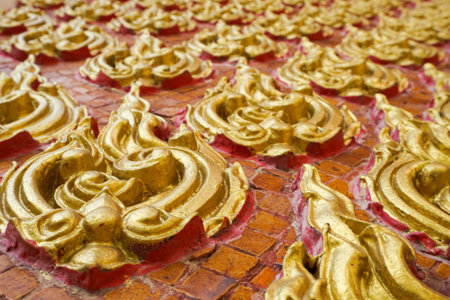 Close up art thai style on public temple wall at Thailandの写真素材