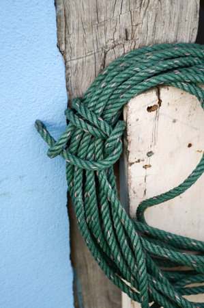 closeup green rope on wood poleの写真素材
