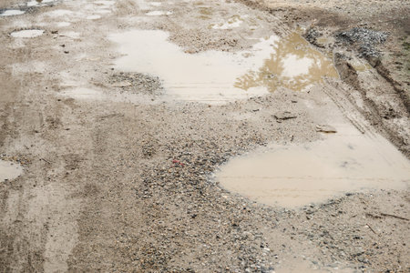 wheel track on dirt soil texture after rainingの写真素材