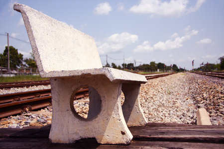 cement chair on stone floor near train stationの写真素材