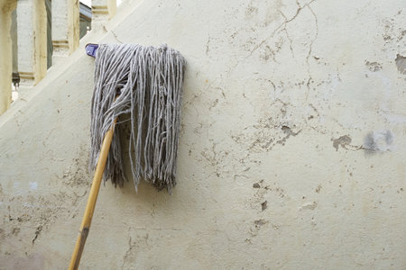 old mop on cement wallの写真素材