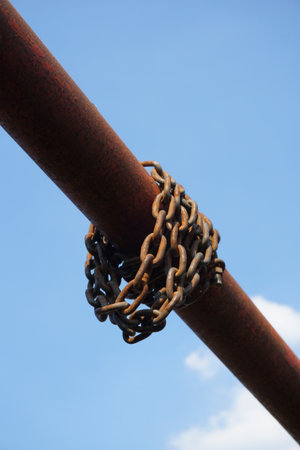 old chain on iron poleの写真素材
