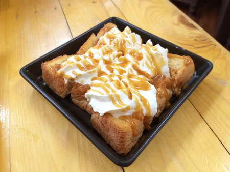 bread and honey on wooden tableの写真素材