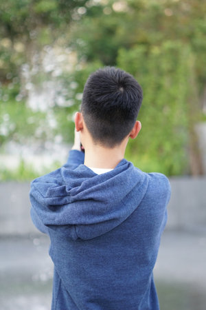 close up young man take a photo in nature gardenの写真素材