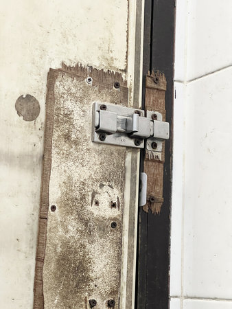 metal lock with water drops on the wall of buildingの写真素材