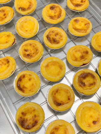 Egg tart or portuguese egg tart on recycled paper.