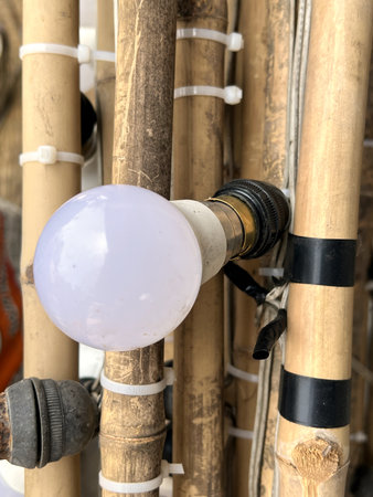 close up light bulb on wooden poles