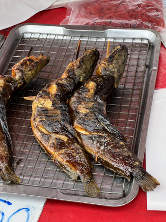 close up view of delicious asian food, grilled catfish in marketの写真素材